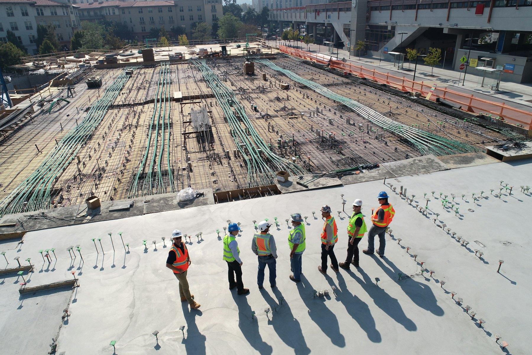 Site team in high-visibility vests on a construction platform